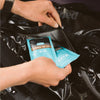 a woman adding two BUBS Naturals MCT Oil Powder sample packets to a gym bag